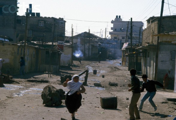 10 Feb 1988, Gaza, Gaza Strip --- Civilians flee gunfire from armed soldiers in the streets of Gaza. Violence broke out after rebel Israeli and Palestinian fighters protested in the occupied territory of Gaza during the first Intifada. --- Image by Patrick Robert/Sygma/CORBIS