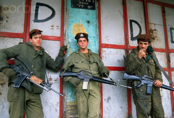 13 Feb 1988, Gaza, Gaza Strip --- Three armed soldiers patrol the streets of Gaza to impose a curfew. Violence broke out after rebel Israeli and Palestinian fighters protested in the occupied territory of Gaza during the first Intifada. --- Image by Patrick Robert/Sygma/CORBIS