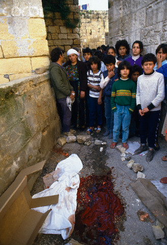 20 Feb 1988, Ramallah, West Bank --- Young mourners gather for a funeral near the bloody ground where a Palestinian civilian died during the uprising in Ramallah. Violence broke out after rebel Israeli and Palestinian fighters protested in the disputed territory of West Bank during the first Intifada. --- Image by Patrick Robert/Sygma/CORBIS