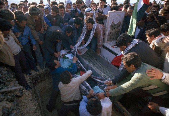 20 Feb 1988, Ramallah, West Bank --- During a funeral, mourners carrying Palestinian Liberation Organization flags protest the death of a Palestinian killed during the uprising in Ramallah. Violence broke out after rebel Israeli and Palestinian fighters protested in the disputed territory of West Bank during the first Intifada. --- Image by Patrick Robert/Sygma/CORBIS