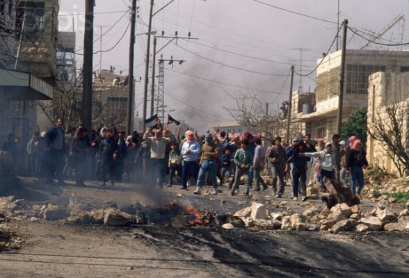 24 Feb 1988, Beit Ummar, West Bank --- Palestinian demonstrators throw stones at Israeli soldiers during a protest in the streets of Beit Omar. Violence broke out after rebel Israeli and Palestinian fighters protested in the disputed territory of West Bank during the first Intifada. | Location: Beit Omar, West Bank.  --- Image by Patrick Robert/Sygma/CORBIS
