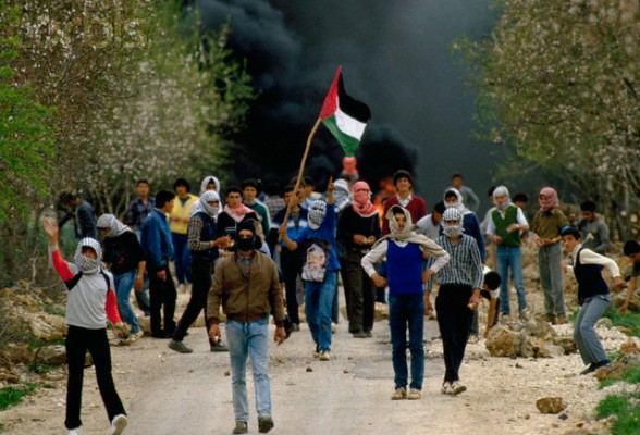 29 Feb 1988, West Bank --- Palestinian demonstrators wave Palestinian Liberation Organization flags, outlawed by Israel, during an uprising. Violence broke out after rebel Israeli and Palestinian fighters protested in the disputed territory of West Bank during the first Intifada. --- Image by Patrick Robert/Sygma/CORBIS