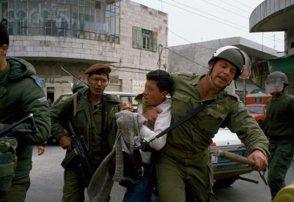 February 1988, West Bank --- Soldiers arrest a Palestinian demonstrator during an uprising. Violence broke out after rebel Israeli and Palestinian fighters protested in the disputed territory of West Bank during the first Intifada. --- Image by  Patrick Robert/Sygma/CORBIS