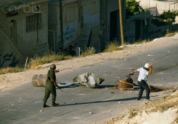 22 May 1990, Shu'fat, East Jerusalem, West Bank --- Israeli soldiers respond to rioting Palestinians in Shufat, Jerusalem. The riot is in response to a shooting by a discharged Israeli soldier that occurred two days before in Rishon le-Ziyyon, which killed eight Palestinian laborers and wounded nine others. --- Image by Patrick Robert/Sygma/Corbis