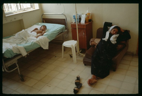 06 Sep 1990, Jerusalem, Israel --- Woman sleeping by young wounded Palestinian at Makassed hospital in Jerusalem. The "Intifada hospital" depends on financing from Kuwait and Saudi Arabia. --- Image by Antoine Gyori/Sygma/Corbis