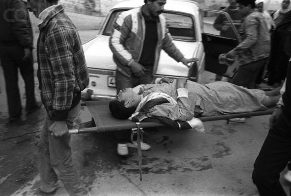 1988-1989, Gaza, Gaza Strip --- A Palestinian boy, wounded in a street clash with Israeli soldiers, is carried on a stretcher into the emergency room of Ahli Arab Hospital in Gaza City. --- Image by © Keith Dannemiller/Corbis
