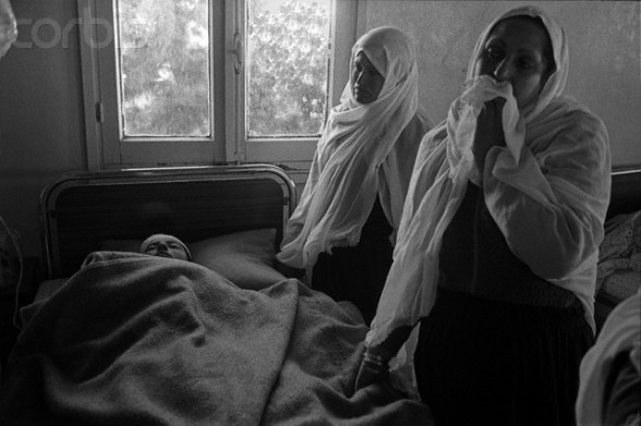 1988-1989, Gaza, Gaza Strip --- Two women watch over a young boy in a coma at Al-Shifa Hospital in Gaza City. He was admitted to the hospital after suffering wounds in a street confrontation with Israeli soldiers. The boy's mother is on the right. --- Image by © Keith Dannemiller/Corbis