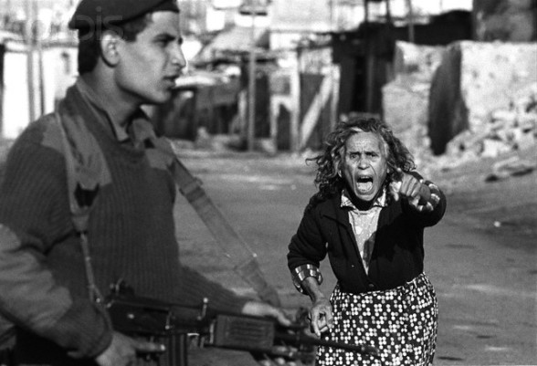 1988-1989, Gaza, Gaza Strip --- A Palestinian woman yells at Israeli soldiers who have just arrested one of her sons after a street confrontation in Beach Camp for refugees in the Gaza Strip. --- Image by © Keith Dannemiller/Corbis