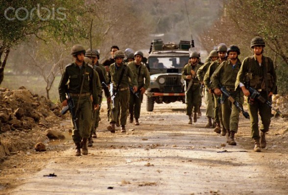 January 1988, West Bank --- Government soldiers patrol a road on the West Bank during the Intifada. --- Image by  Ricki Rosen/CORBIS SABA
