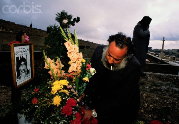 25 Dec 1988, Jerusalem, Israel --- A Palestinian man visits the grave of 15-year-old Nidel, who was killed in the Intifada, a violent uprising by Palestinians against the Israeli occupation. --- Image by Ricki Rosen/CORBIS SABA