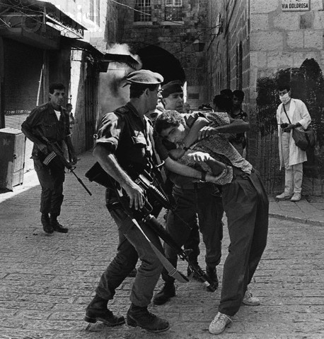 ca. 1991, Jerusalem, Israel --- Israeli soldiers tussle with a young Palestinian suspected of throwing stones on the Via Dolorosa. --- Image by  David H. Wells/CORBIS