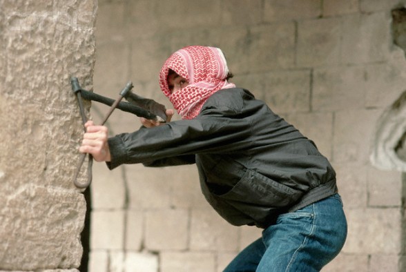 ca. April 1988, West Bank --- A Palestinian shabiba (youth) takes aim with a slingshot during the Intifada. --- Image by  Jeffrey L. Rotman/CORBIS