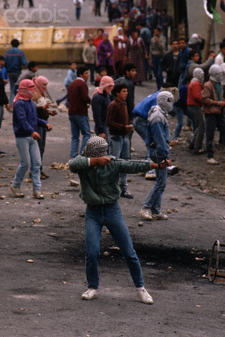 1988, West Bank --- Masked guerrillas fight in the Intifada, the Palestinian uprising against Israeli occupation. --- Image by Peter Turnley/CORBIS