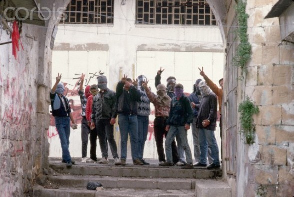 1988, Nablus, West Bank --- Masked Palestinian Guerrillas Giving Hand Signs --- Image by Peter Turnley/CORBIS