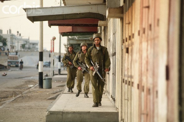 December 1993, Gaza, Gaza Strip --- Three armed Israeli soldiers patrol an urban street in Gaza. --- Image by Peter Turnley/CORBIS