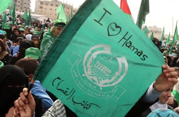A Palestinian supporter of Hamas holds t