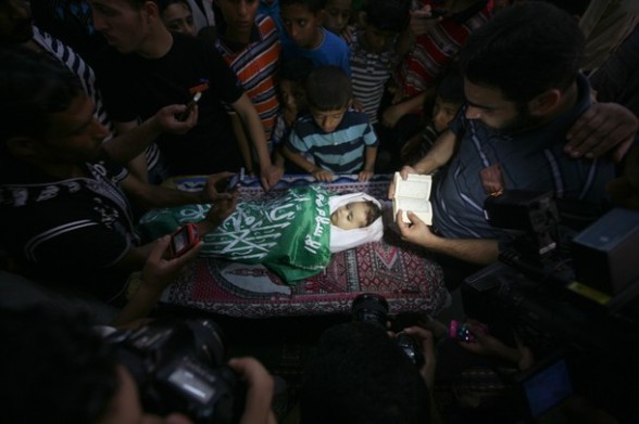 Palestinian mourners pray over the body of two-year-old girl, Hadeel al-Hadad, in the mosque during her funeral in Gaza City, on June 20, 2012.  (Photo credit MAHMUD HAMS/AFP/GettyImages)