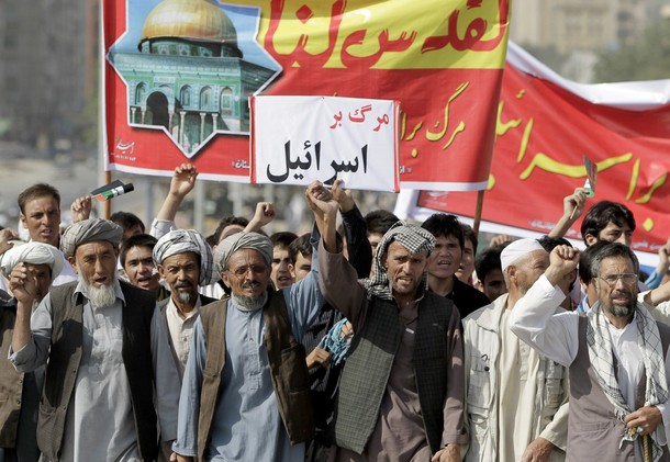 Afghan men shout anti-Israel slogans and hold a small placard that reads, in Dari, "death to Israel," during a protest in Kabul, Afghanistan, August 17, 2012. Hundreds of demonstrators took to the streets of Kabul on Friday on Al-Quds Day, the last Friday of the Islamic holy month of Ramadan, to show support for the Palestinian people and to demonstrate the importance of the city of Jerusalem to Muslims. Al-Quds is the Arabic name for Jerusalem, where Muslims believe Islam's Prophet Muhammad began his journey to heaven. (AP Photo/Ahmad Jamshid)
