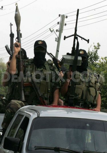 Members of the Ezzedine al-Qassam brigades the armed wing of Hamas, carry their weapons as they celebrate a truce between Gaza and Israel - Nov 21 2012 Photo by Abed Rahim Khatib