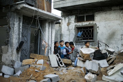 Palestinian boys stand next to the destroyed house of Hejazi family after what Hamas Health Ministry said was an Israeli air strike in the northern Gaza Strip November 20, 2012. Four members of the same Hejazi family - four-year-old twin boys and their parents - were killed in the Israeli air strike in Gaza on Monday, the Hamas Health Ministry said. Israel had no immediate comment on the attack, one of more than 80 bombings during the day in the Hamas-ruled territory, where Israel launched an aerial offensive on Wednesday it says is intended to quell rocket fire at its cities. REUTERS/Suhaib Salem