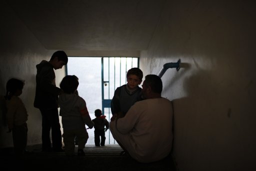 Displaced Palestinians, who fled their houses, gather at a staircase as they stay at a United Nations-run school in Gaza City November 20, 2012. From the sandy expanses of the northern Gaza Strip, Palestinian families are fleeing their homes destroyed by airstrikes, but refuse to blame the Hamas rocket crews who draw Israeli fire. REUTERS/Ahmed Jadallah