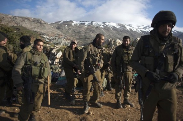 Israeli soldiers wait near an outpost at the Syrian-Israeli ceasefire close to the Druze village of Majdal Shams in the Golan Heights March 30, 2012. Israel deployed thousands of extra security forces nationwide on Friday, reinforcing border crossings with Lebanon and Syria and shutting crossings with the occupied West Bank after Palestinian groups announced plans to march on Israel's borders on a day when Israeli Arabs mark  Land Day , the annual commemorations in Israel of the killing by police of six Arab citizens in 1976 during protests against land confiscations in northern Israel's Galilee region. REUTERS/ Nir Elias