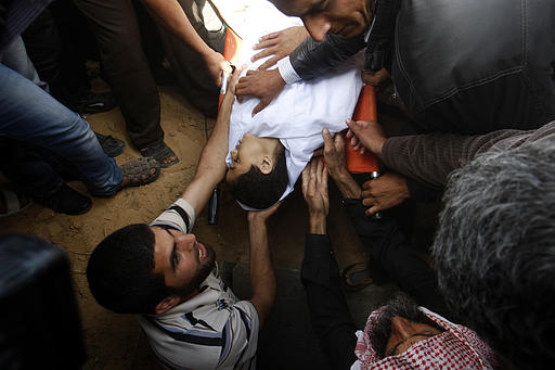 People bury Ahmed Abu-Daqa, 11, in Khan Younis, southern Gaza Strip, Sunday, Oct. 28, 2012. It was not clear who shot the boy. Palestinian militants and Israeli forces were exchanging fire at the time when the boy was killed Thursday evening. Photo by AP